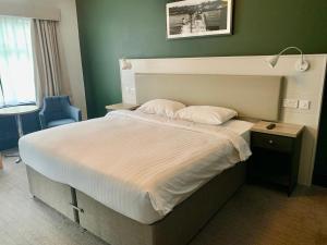 a bedroom with a large bed with a white comforter at Park Inn by Radisson Bournemouth in Bournemouth