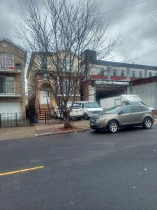 a car parked on the side of a street at Cosy Bedroom 12mins to Airport Prudential NJIT UMDJ Penn Station in Newark