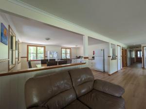 a living room with a couch and a kitchen at Kiarabilli in Bulwer