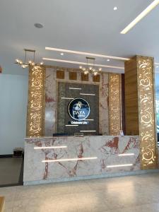 a lobby with a marble counter and a sign on the wall at Daya by Renai in Cochin