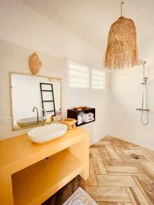 a bathroom with a sink and a mirror at VOVO TELO LODGE in Toliara