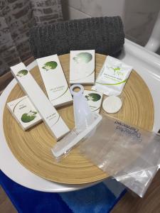 a table with certificates and a remote control on it at Apartman Sparta in Sombor