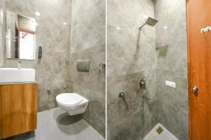 uma casa de banho com um chuveiro, um WC e um lavatório. em FabExpress Royal MG em Ludhiana