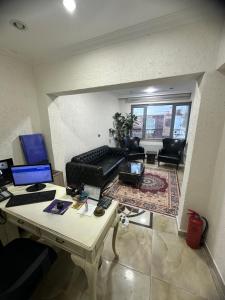 a living room with a couch and a desk with a laptop at BİG ORANGE HOTEL in Istanbul