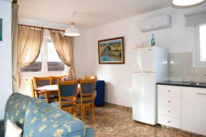 a kitchen and dining room with a table and a refrigerator at Merika Complex 1 Hou.32 in Larnaca