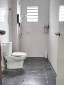 a white bathroom with a toilet and a shower at 1793 Kepayang S2 # U Homestay in Seremban