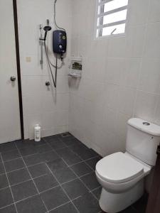 a bathroom with a toilet and a shower at 1793 Kepayang S2 # U Homestay in Seremban +14 photos