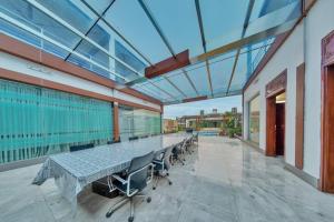 a large room with a long table and chairs at Grand Villa Oasis in Dhaka