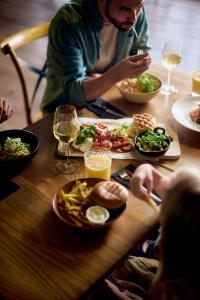 a group of people sitting at a table eating food at Naantali Spa Hotel in Naantali