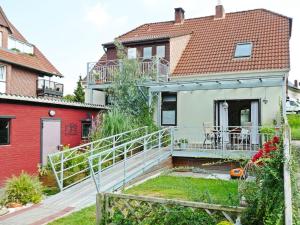 a house with a staircase in front of a house at Landgang I 90qm² mit Garten in Elsfleth