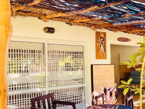 a patio with two chairs and a window at VOVO TELO LODGE in Toliara