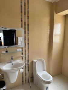 a bathroom with a toilet and a sink at Marhaba Retreats in Muscat