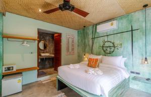 a bedroom with a large white bed in a room at Dreamcatcher Boutique Hotel in Bophut