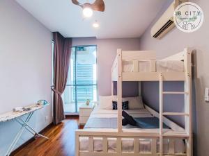 a bedroom with two bunk beds and a window at Puteri Harbour by JBcity Home in Nusajaya
