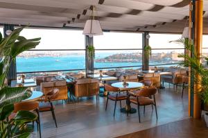 a restaurant with tables and chairs and a view of the ocean at Ring Stone Hotels Bosphorus - Special Class in Istanbul