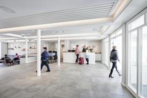 un groupe de personnes se promenant dans un hall dans l'établissement Siglo Hotel by Keahotels, à Siglufjörður