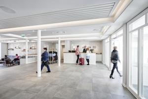 a group of people walking through a lobby at Siglo Hotel by Keahotels in Siglufjörður