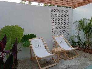 two chairs and a table on a patio at The Tropical Koh Mook in Koh Mook