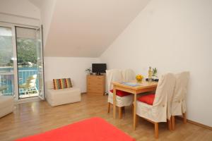 a dining room with a table and chairs at Apartments by the sea Slano, Dubrovnik - 8538 in Slano