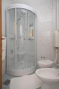 a white bathroom with a shower and a toilet at Apartments by the sea Slano, Dubrovnik - 8538 in Slano
