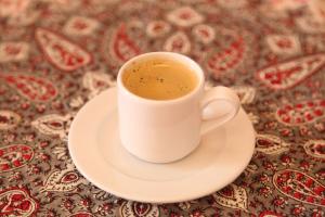 een kopje koffie op een bord op een tafel bij Tulia Old Town in Mombasa +16 foto's