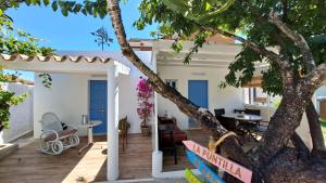 um pátio com uma árvore em frente a uma casa em Casa con encanto junto a la playa de La Puntilla em El Puerto de Santa María