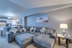 a living room with a couch and a table at Charming Retreat With Modern Comforts in West Fargo