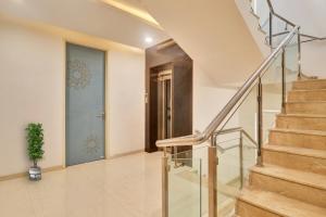 a hallway with stairs and a blue door at OYO Flagship Ekasila Suites in Hyderabad