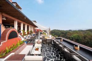 a balcony with tables and chairs on a building at The Sierra - By The Lake in Udaipur