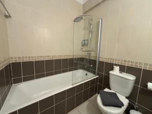a bathroom with a tub and a toilet and a sink at Cozy Apartment in Paphos Beautiful Complex in Paphos +16 photos