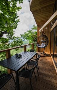 a wooden deck with a table and chairs on it at North-House Orava in Veličná