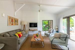 a living room with a couch and a table at 3 Bedroom Villa with pool and garden in Grand Baie in Grand-Baie