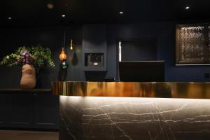 a reception desk in a room with a counter at Quality Hotel Florø in Florø