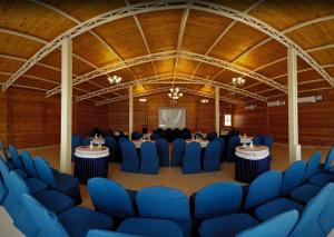 a large room with blue chairs and tables in it at The Regalia Resort in Mandrem +59 photos