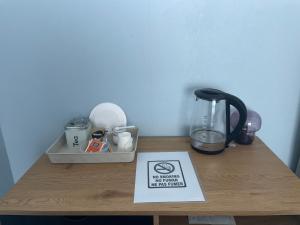 a table with a blender and a sign on it at Cozy Blue Apartment in Vantaa