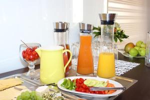 a table with a plate of food and bottles of juice at Haus Anna an der Stadtmauer in Hanau am Main