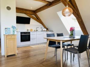 a kitchen with a dining room table and chairs at Ferienwohnung Haus Alpenblick in Lenzkirch