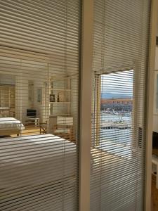 a room with a large window with blinds on it at Monolocale La Darsena in Portoferraio