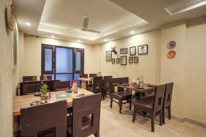 a dining room with wooden tables and chairs at Hotel Hill View, Mussoorie - Near Mall Road Mussoorie in Mussoorie