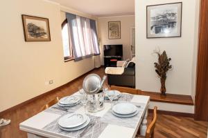 a dining room and living room with a table and chairs at L' Antica Piazzetta in Franciacorta in Capriolo