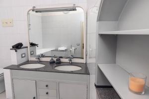 a bathroom with two sinks and a mirror at L' Antica Piazzetta in Franciacorta in Capriolo