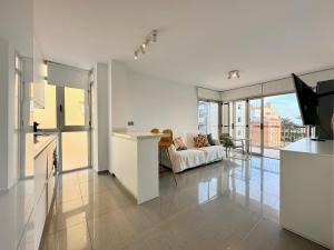 a white living room with a couch and a television at Zarauz sea views. Águilas Costa Cálida. in Águilas