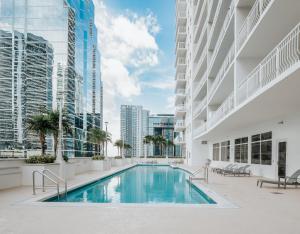 a swimming pool in the middle of a building with buildings at Bay Front Highrise Oasis in Brickell in Miami