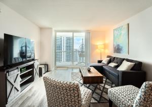 a living room with a couch and a table at Bay Front Highrise Oasis in Brickell in Miami