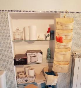 a shelf in a bathroom with toiletries on it at La Mansarda di Didi in Capannori +7 photos
