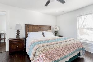 a white bedroom with a bed and a ceiling fan at Historic Culpeper Farmhouse in Culpeper
