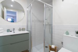 a bathroom with a shower and a sink and a mirror at Budget Beach Studio 23 in Sant Antoni de Calonge