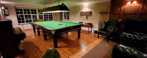 a living room with a pool table in it at Modern and spacious 2 bedroom apartment with free parking in Glyn-Ceiriog