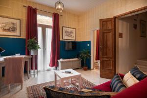 a living room with a couch and a table at Concetta Studio Apartments by Holihomes in Cospicua