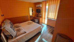 1 dormitorio con 1 cama blanca en una habitación en Hotel Toni en Bukovlŭk